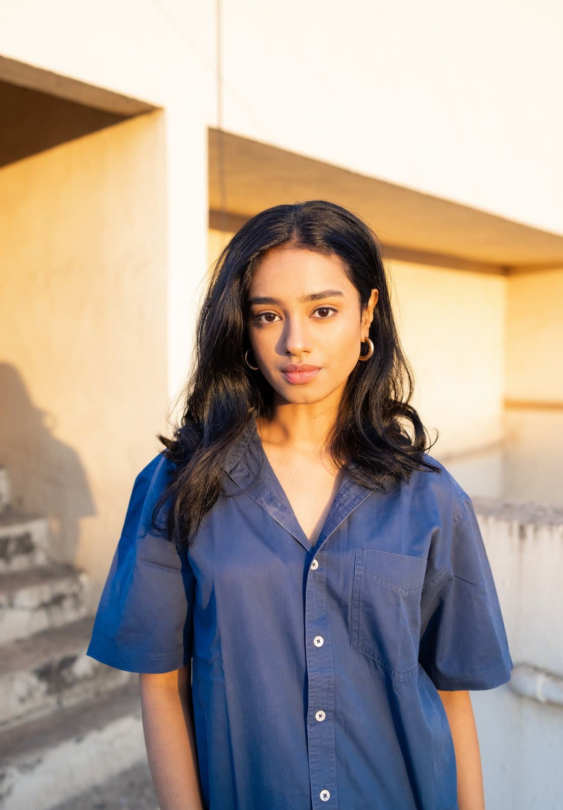 Malavika in a soft blue shirt, direct portrait